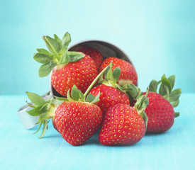 Handful of strawberries on blue background