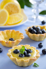 Delicious tarts with lemon cream and blueberries.