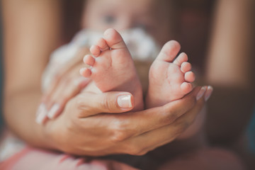 Fototapeta Masseur massaging little baby's foot, shallow focus obraz