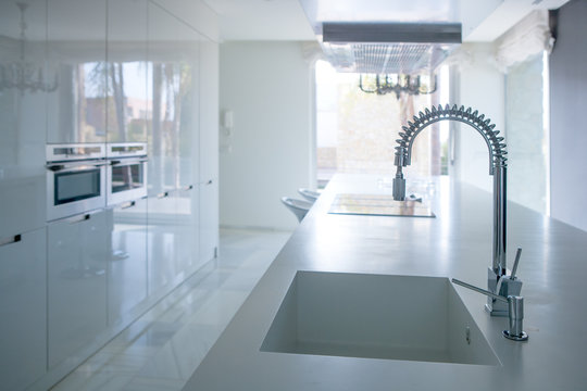 Modern white kitchen perspective with integrated bench