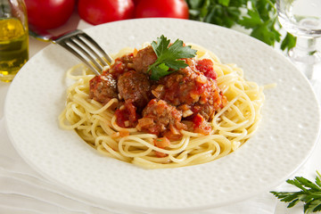 Pasta with meatballs in tomato sauce.