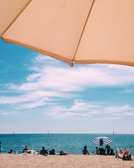 sunbathing under umbrella