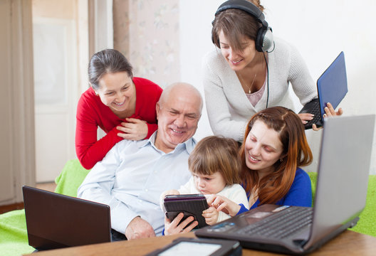 Family Of Three Generations Uses Few Various Electronic Device