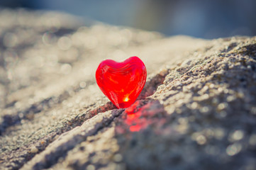 macro red heart on a vintage cream wall