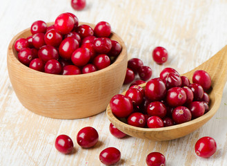 Cranberries in a  wooden spoon