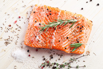 Salmon filet on a wooden carving board.