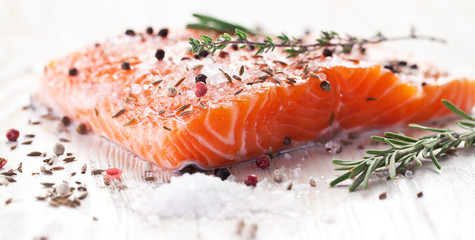 Salmon filet on a wooden carving board.