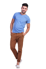 Fototapeta premium casual man standing with hands in pockets and smiles