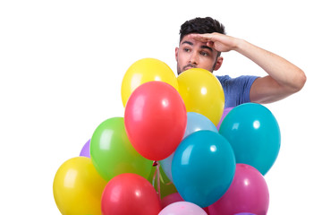 Fototapeta na wymiar man behind a bunch of baloons is looking away