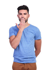 casual young man covering his mouth