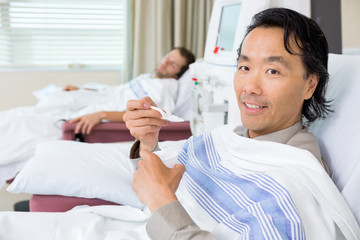 Portrait Of Patient Eating Crushed Ice During Dialysis