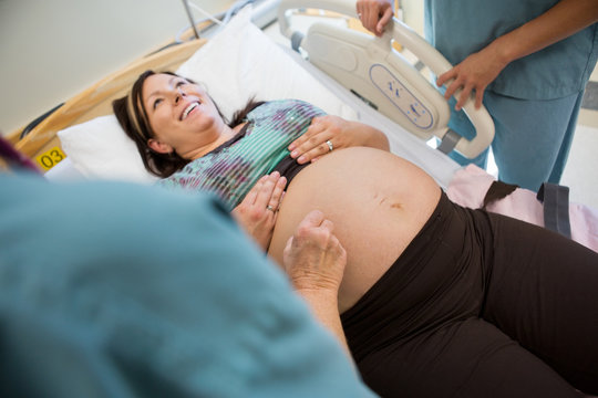 Pregnant Woman Being Examined By Nurses