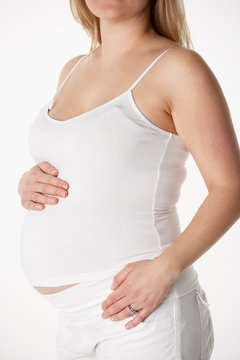 Close Up Studio 6 months Portrait Of Pregnant Woman Wearing Whit