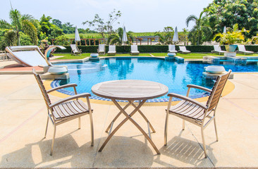 Table and chairs beside the pool