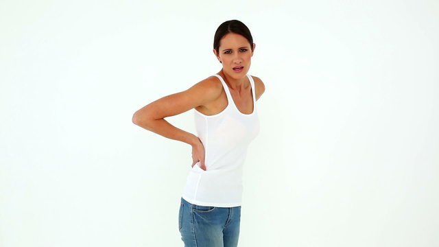 Slim model in jeans with a back ache
