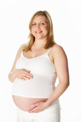 Studio Portrait Of 8 Months Pregnant Woman Wearing White