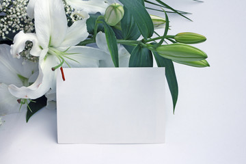 White lily flowers and post card
