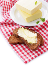 Slice of rye bread with butter, isolated on white