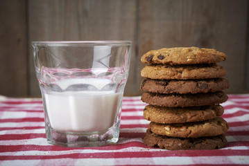 chocolate chip cookies with glass of milk on table red wagon - Powered by Adobe