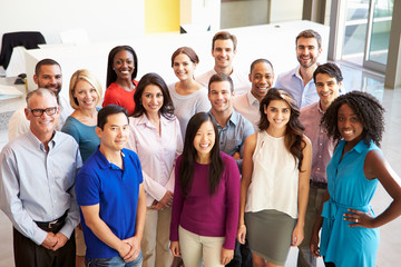 Portrait Of Multi-Cultural Office Staff Standing In Lobby