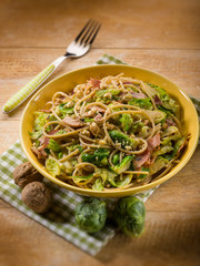 pasta with ham brussel sprout and nuts, selective focus