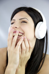 Happy woman laughing while listening music