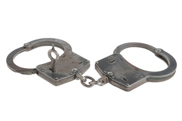 Handcuffs with a key within on white