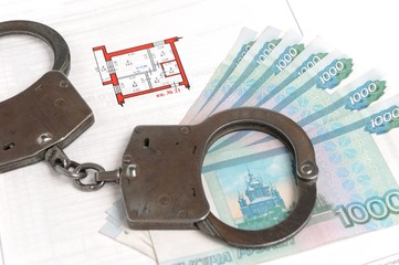 Handcuffs, money and technical passport with the plan of the apa