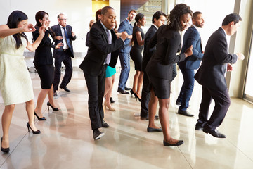 Businessmen And Businesswomen Dancing In Office Lobby - Powered by Adobe