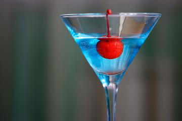 Cocktails of different colors spilled on glass glasses