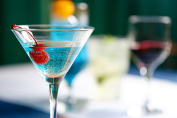 Cocktails of different colors spilled on glass glasses
