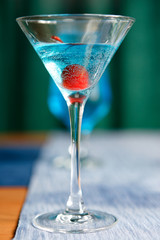 Cocktails of different colors spilled on glass glasses