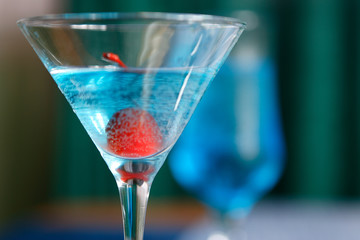 Cocktails of different colors spilled on glass glasses
