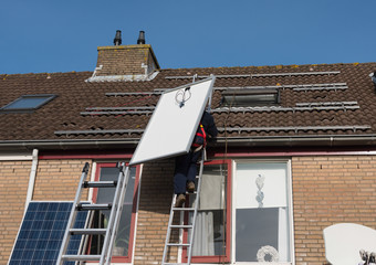 man climbing the ladder with solar panel