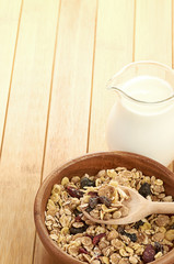 Plate with raw oatmeal on wooden table.
