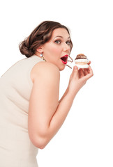 Beautiful plus size woman eating pastr