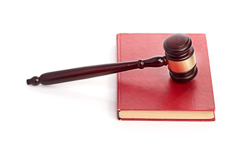 Judge's gavel on red legal book