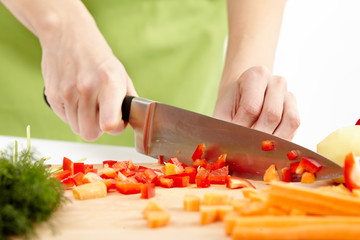 Young lady chopping vegetables © Xalanx