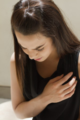 Fototapeta premium heart problem or chest pain, female model