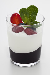 Still life of yogurt, berries, jam and mint