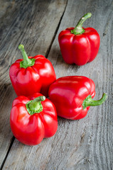 Red bell peppers on the wooden background