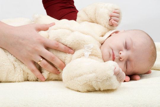 Mother Holding The Sleeping Baby In Her Arms