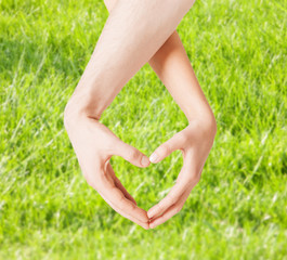 woman and man hands showing heart shape
