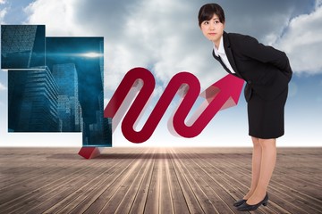 Composite image of serious businesswoman bending