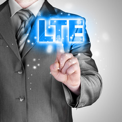businessman is pushing his finger on lte button