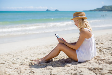 Caucasian business woman on beach tablet pc