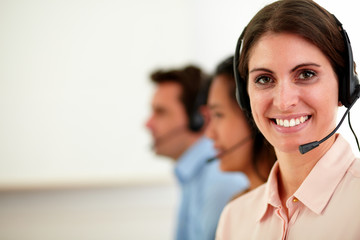Fototapeta premium Young operator woman smiling at you
