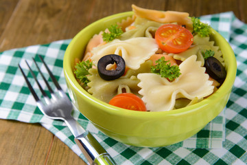 Delicious pasta with tomatoes on plate on table close-up