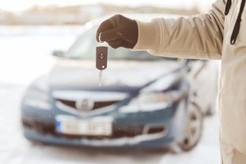 closeup of man hand with car key outdoors
