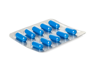 Blue medication capsules in blister pack close-up